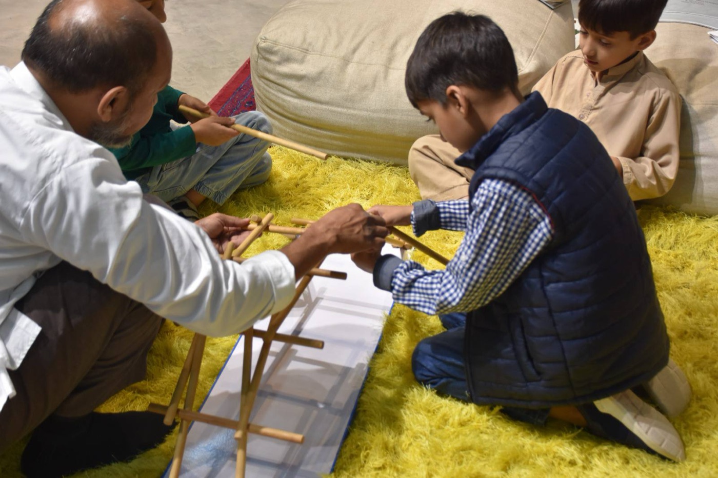 Children working together on a hands-on learning activity at The House of Wisdom