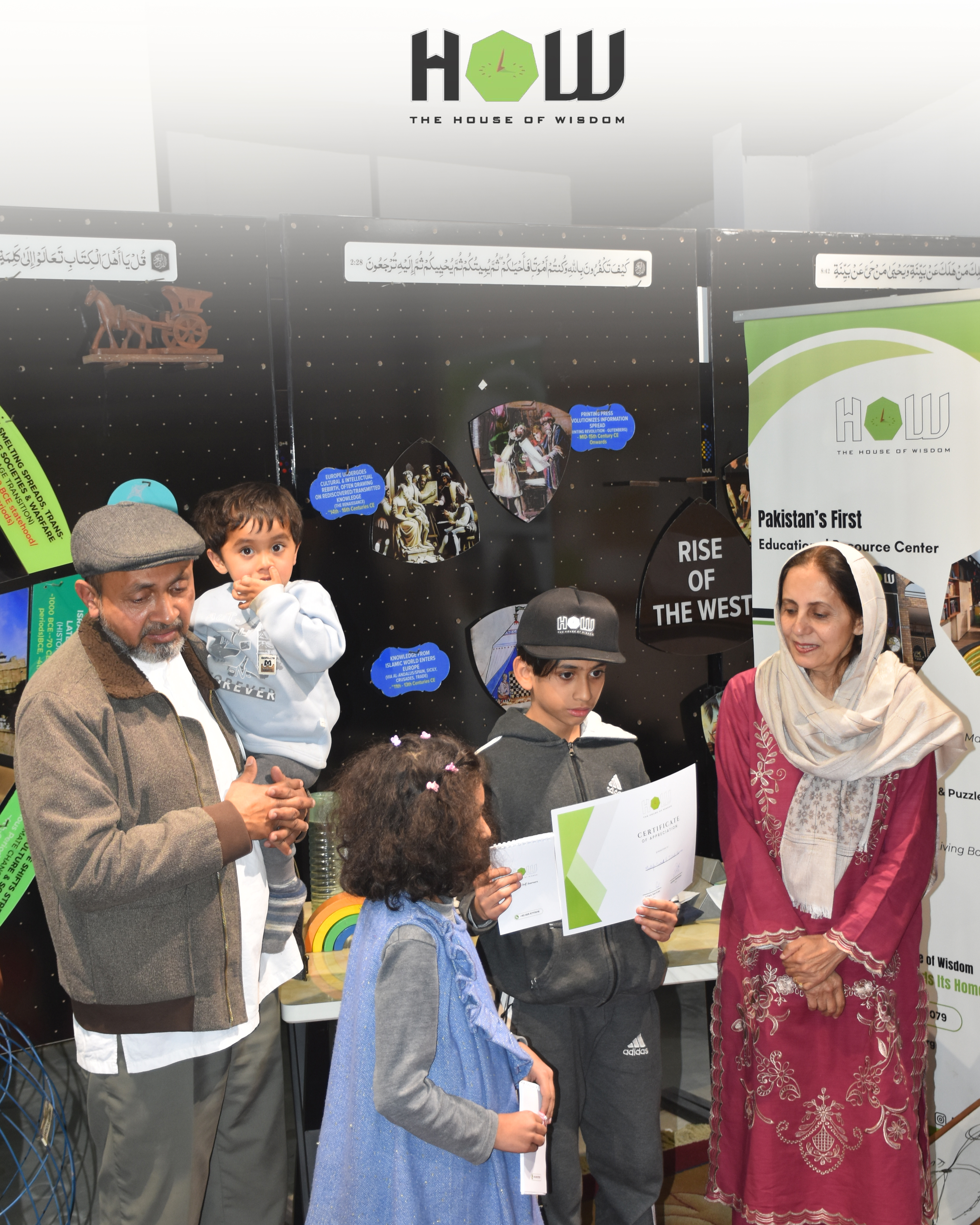 Pride — a family proudly receiving their child's certificate