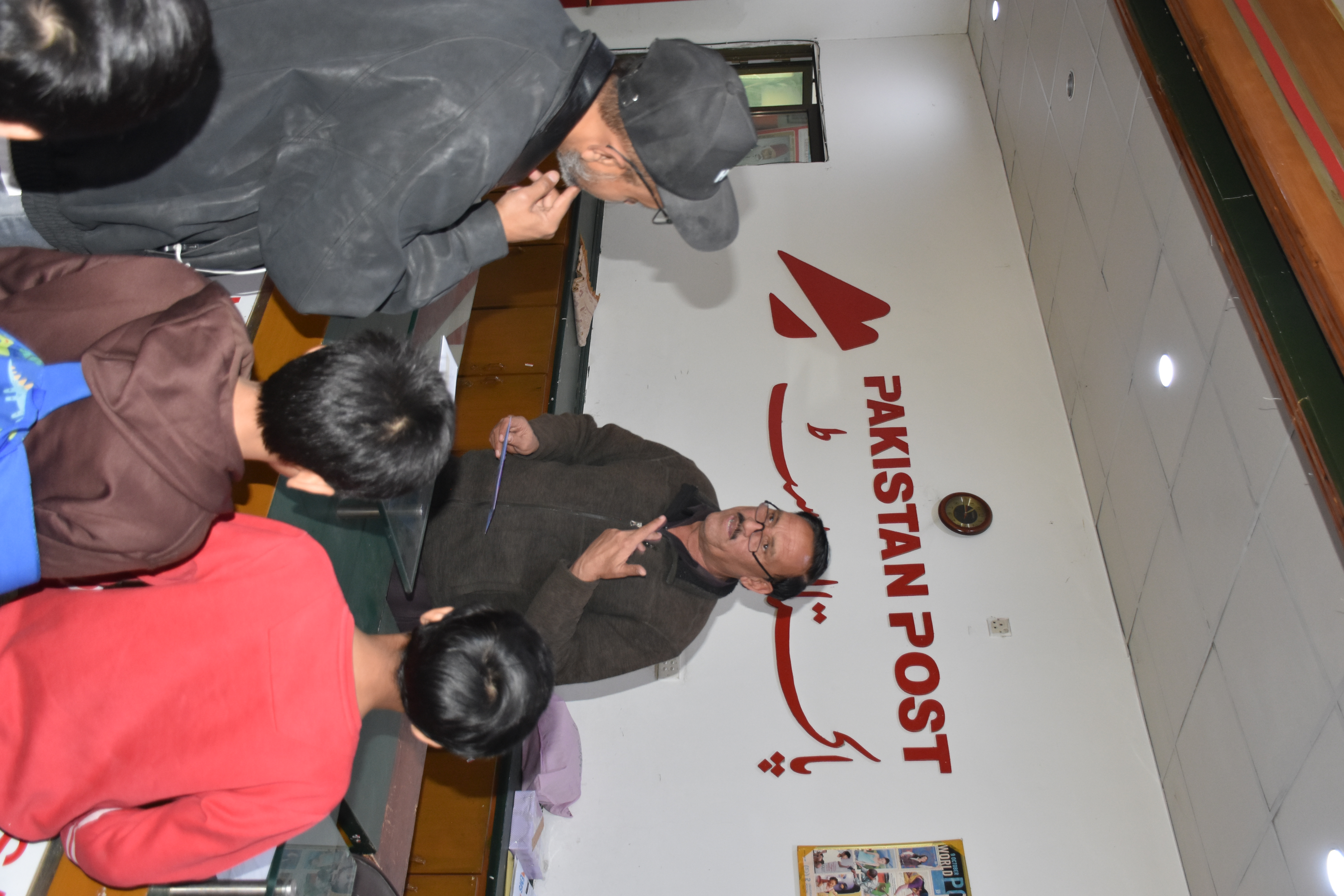 Operations — A postal officer walks young visitors through the daily workings of Pakistan Post.